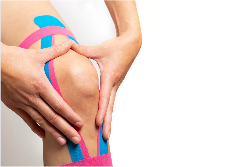 Knee with kinesiology tape applied for joint stability and pain relief during Kinesio Taping therapy at Balance Naturopathic & Acupuncture in Mooresville, NC.